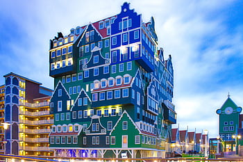 Distinctive stacked building design in Zaandam, Netherlands, during twilight. HD wallpaper
