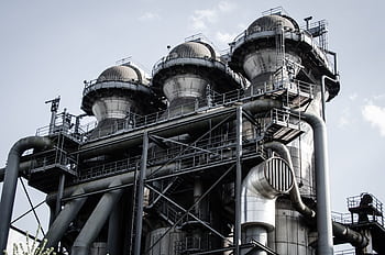 A powerful industrial structure with pipes and machinery in Duisburg, Germany. HD wallpaper