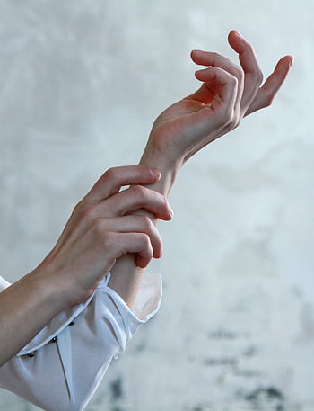 A close-up of elegant female hands in soft natural light, creating a minimalist and artistic aesthetic. HD phone wallpaper