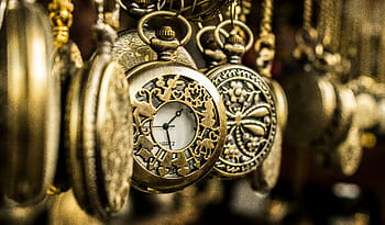 Close-up of ornate vintage pocket watches showcasing intricate designs and luxury aesthetics. HD wallpaper