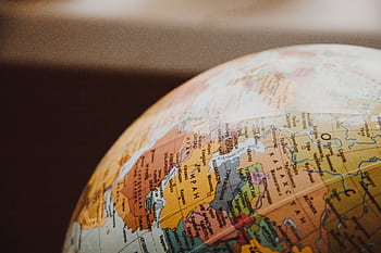 Detailed close-up of a globe showcasing parts of Europe and Asia for world exploration concepts. HD wallpaper