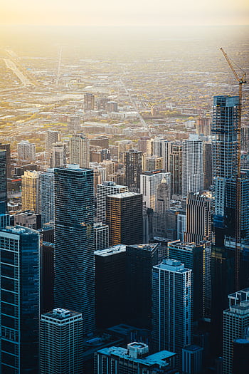 Breathtaking aerial shot of a bustling cityscape with towering skyscrapers at sunset HD phone wallpaper