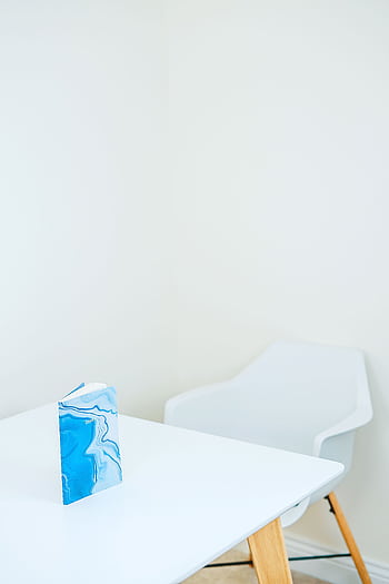 Modern white room with a blue notebook on a wooden table. HD phone wallpaper