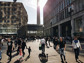 A busy shopping street in Berlin with pedestrians enjoying a sunny day in the city center. HD wallpaper