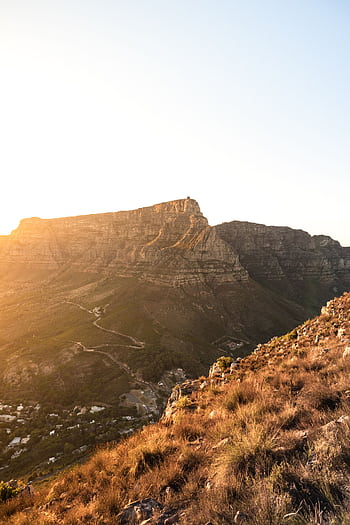 Golden light casts a warm glow over the iconic Table Mountain in Cape Town, South Africa. HD phone wallpaper