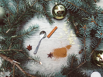 A Christmas wreath with spices and ornaments on a wooden background, capturing a cozy festive atmosphere. HD wallpaper