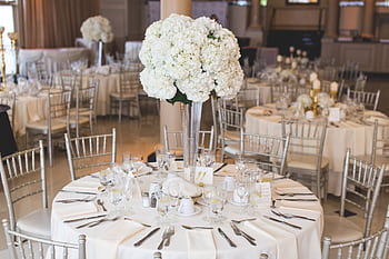 Beautifully decorated wedding reception table with elegant floral centerpiece and silverware. HD wallpaper