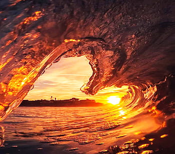 Stunning capture of a wave during sunset, creating an artistic view in Huanchaco, Peru. HD wallpaper