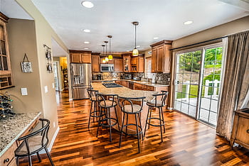A luxurious modern kitchen featuring hardwood floors and granite countertops. HD wallpaper