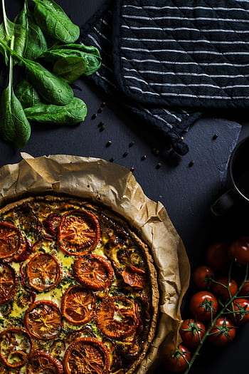 A delicious homemade tomato quiche with fresh spinach, ready to serve, perfect for dinner. HD phone wallpaper