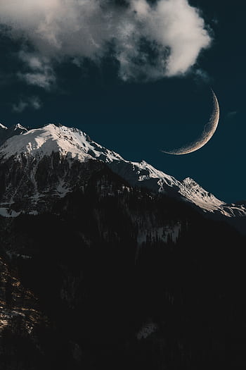 Majestic snow-capped mountains under a crescent moon in a tranquil winter landscape. HD phone wallpaper