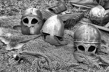 Close-up of historical medieval helmets and armor in black and white. HD wallpaper