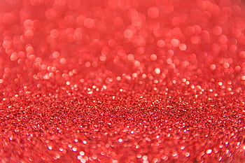 Shimmering red glitter with bokeh effect, ideal for festive backgrounds. HD wallpaper