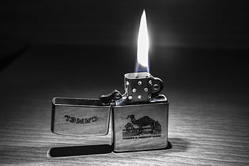Close-up of a lit Zippo lighter with a clear flame. Perfect for themes of heat and light. HD wallpaper