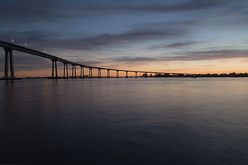Bridge, calm, sea, skyline, sunset HD wallpaper