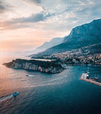Scenic aerial shot of Makarska, Croatia capturing the coastline, island, and majestic mountains at sunset. HD phone wallpaper