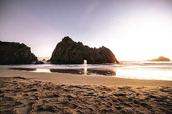 Breathtaking sunset at Pfeiffer Beach highlighting unique rock formations and serene ocean views. HD wallpaper