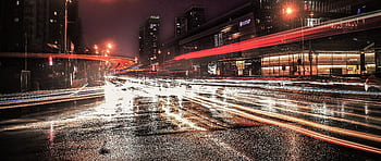 Night view of busy traffic with light trails in Dongcheng, Beijing, creating a vibrant urban scene. HD wallpaper