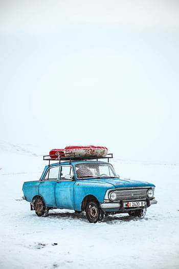 Classic blue car in snowy winter scene, Ak-Talaa District, Kyrgyzstan. HD phone wallpaper