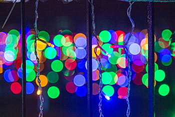 Vibrant bokeh of colorful Christmas lights creating a festive and joyful ambiance. HD wallpaper