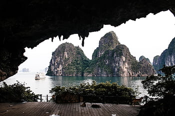 Stunning panoramic view of Ha Long Bay's famous limestone karsts from a cave. HD wallpaper