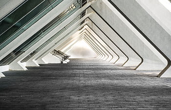 Explore a sleek and contemporary architectural hallway with futuristic design. HD wallpaper