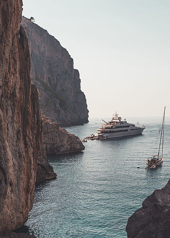 Luxury yacht anchored amidst the stunning cliffs of Escorca, Palma de Mallorca. Perfect vacation escape. HD phone wallpaper
