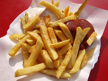 Delicious crispy French fries served with ketchup and mayonnaise on a paper plate HD wallpaper