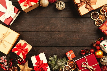 Top view of Christmas gifts and decorations on a wooden table, ideal for holiday backgrounds. HD wallpaper