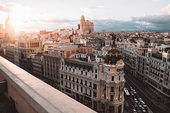 Breathtaking view of Madrid's skyline at sunset featuring the Metropolis Building. HD wallpaper