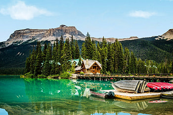 Emerald Lake in Spring, firs, boats, bridge, mountains, cabin HD wallpaper