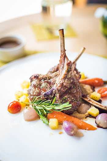 Exquisite plated lamb chops with colorful vegetables, showcasing fine gastronomy. HD phone wallpaper