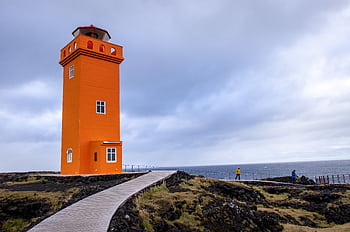 Explore Svörtuloft Lighthouse in Iceland's dramatic landscape with an overcast sky. HD wallpaper