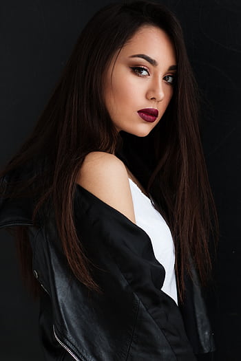 Elegant portrait of a young woman with striking makeup, posing in a black leather jacket. HD phone wallpaper