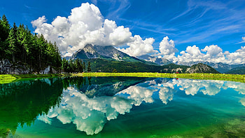 Amazing sky reflection, blue, white, graphy, landscape, grass, rocks, reflection, green, trees, puffy, clouds, sky, , mountains, water HD wallpaper