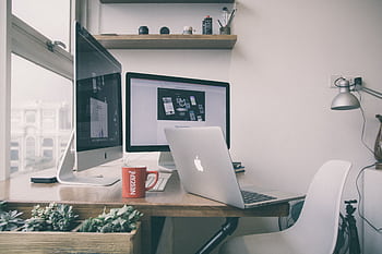 Sleek home office setup with dual monitors, a laptop, and minimalist decor. HD wallpaper
