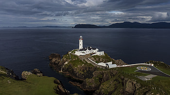 Landscape View Of Mountain Ocean Lighthouse Buildings Road Stones Rocks Under Sky Nature HD wallpaper