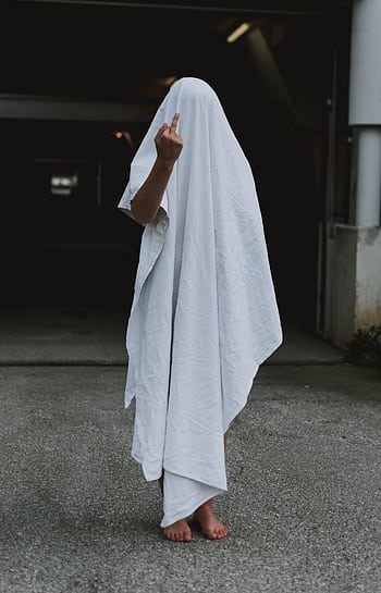 A person covered with a white sheet stands outdoors gesturing with a hand. HD phone wallpaper