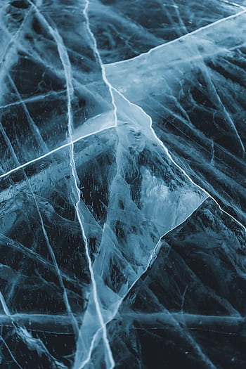 Close-up of the intricate cracked ice formations on Lake Baikal during winter, showcasing natural beauty. HD phone wallpaper