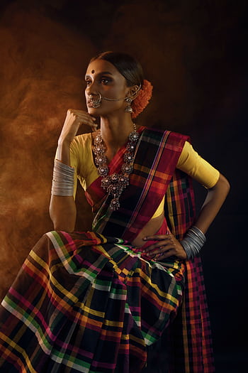 Captivating portrait of an Indian woman in traditional saree, showcasing cultural elegance and style. HD phone wallpaper