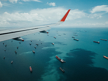 Airplane wing, boat, sea, aerial view HD wallpaper