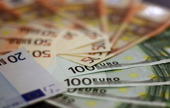 Close-up of various euro banknotes fanned out, symbolizing wealth and financial success. HD wallpaper