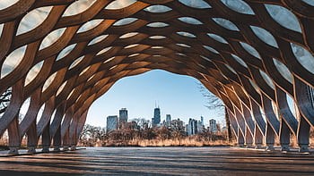 Stunning modern structure framing the Chicago skyline, a perfect blend of architecture and nature. HD wallpaper