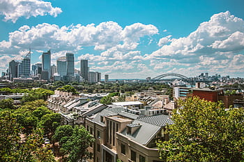 Stunning view of Sydney's skyline featuring the Harbour Bridge and Opera House under a clear blue sky. HD wallpaper