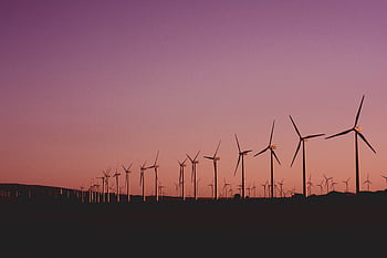 Silhouetted wind turbines at sunset in Zahara de los Atunes, Spain. HD wallpaper
