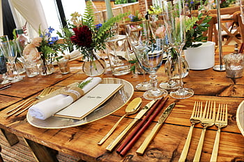 Beautifully arranged table with elegant cutlery and floral decoration, perfect for fine dining. HD wallpaper