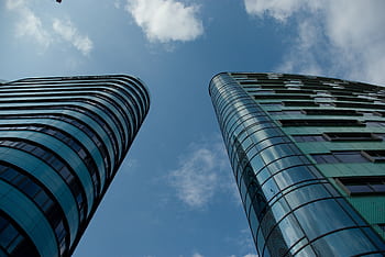 Low angle view of modern glass skyscrapers in an urban setting under a clear blue sky. HD wallpaper