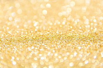 Abstract gold glitter background with a bokeh effect, ideal for festive designs. HD wallpaper