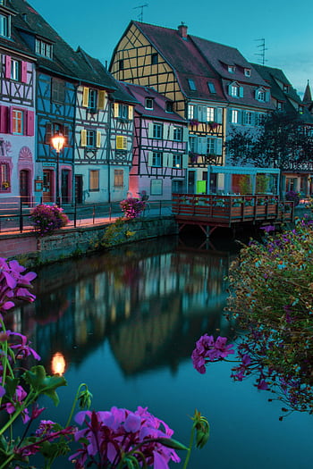 Scenic view of Colmar's colorful houses reflecting in the canal during twilight. HD phone wallpaper