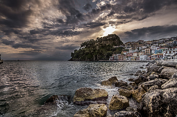 Coastal, rocks, village, apartments, sea, clouds HD wallpaper